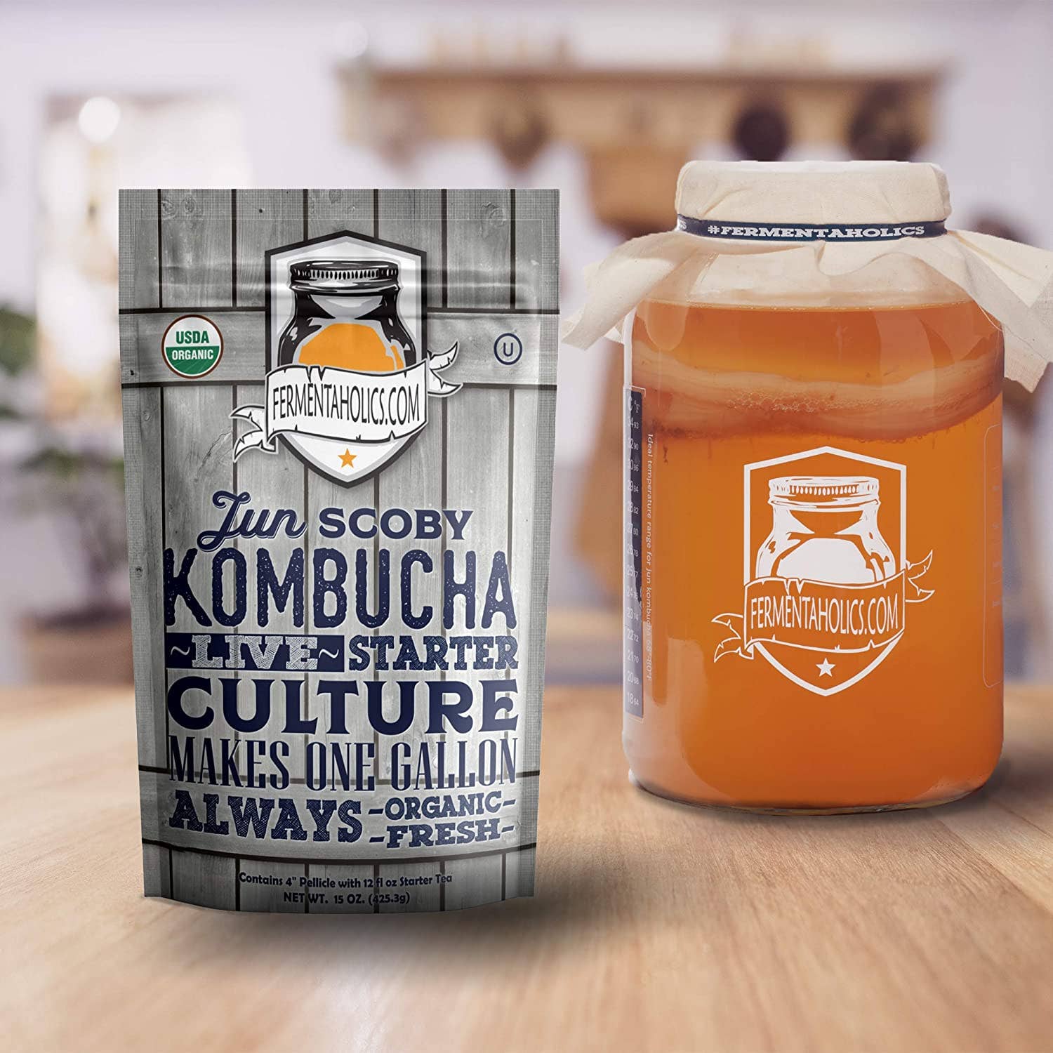 Picture of the scoby package next to a glass bottle with kombucha in it.